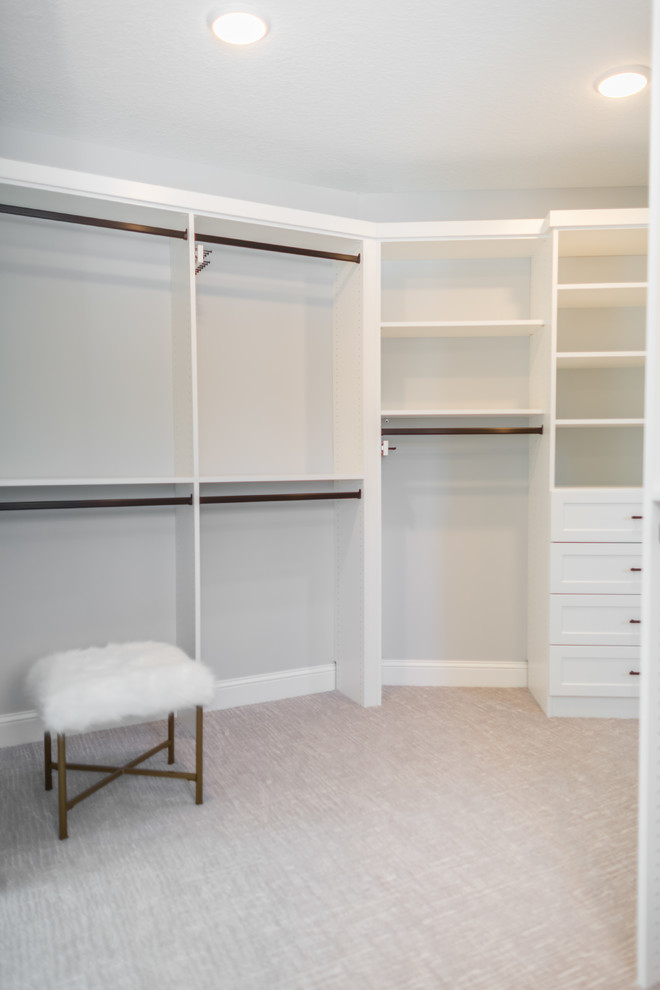 Walk-in closet - mid-sized transitional gender-neutral carpeted and gray floor walk-in closet idea in Minneapolis with shaker cabinets and white cabinets