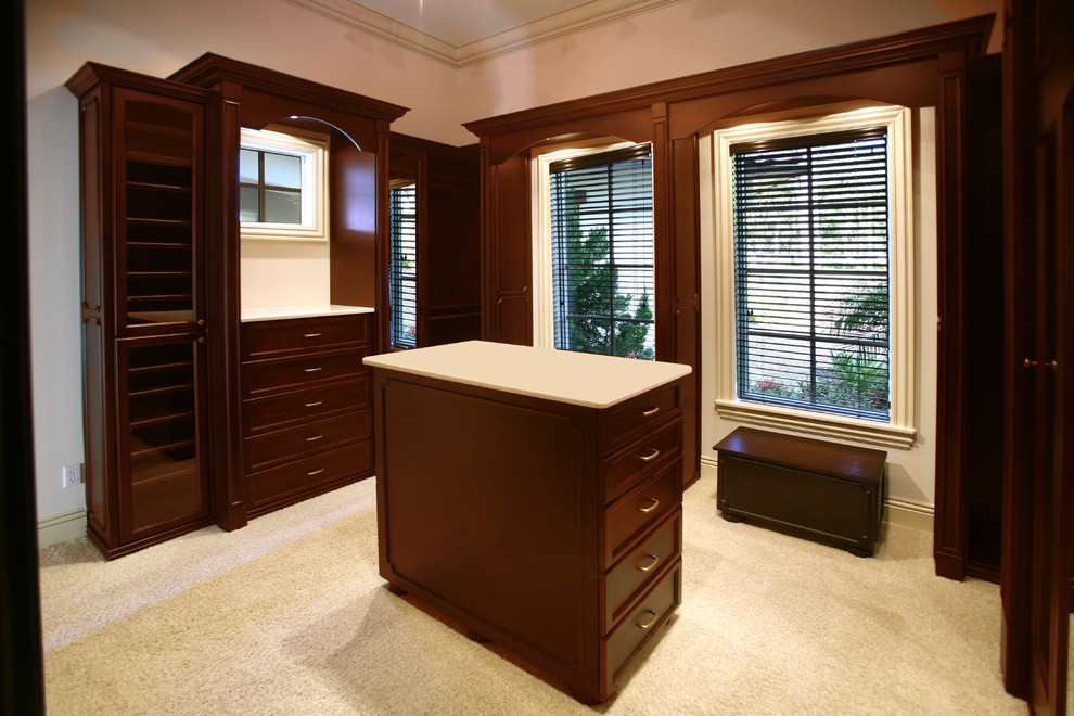 Photo of a traditional wardrobe for men in Orlando with dark wood cabinets.