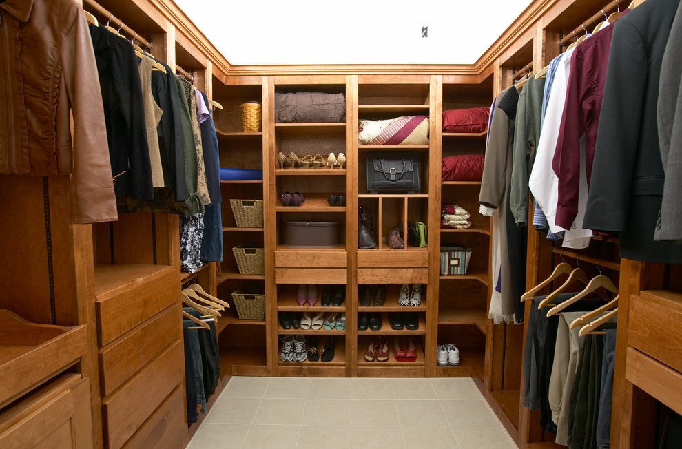 Walk-in closet - large traditional gender-neutral ceramic tile and beige floor walk-in closet idea in St Louis with flat-panel cabinets and medium tone wood cabinets