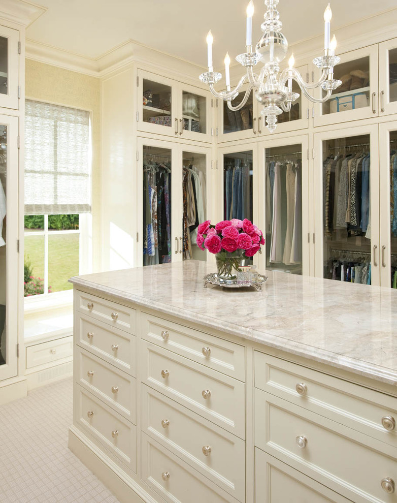 Elegant walk-in closet photo in Dallas with white cabinets