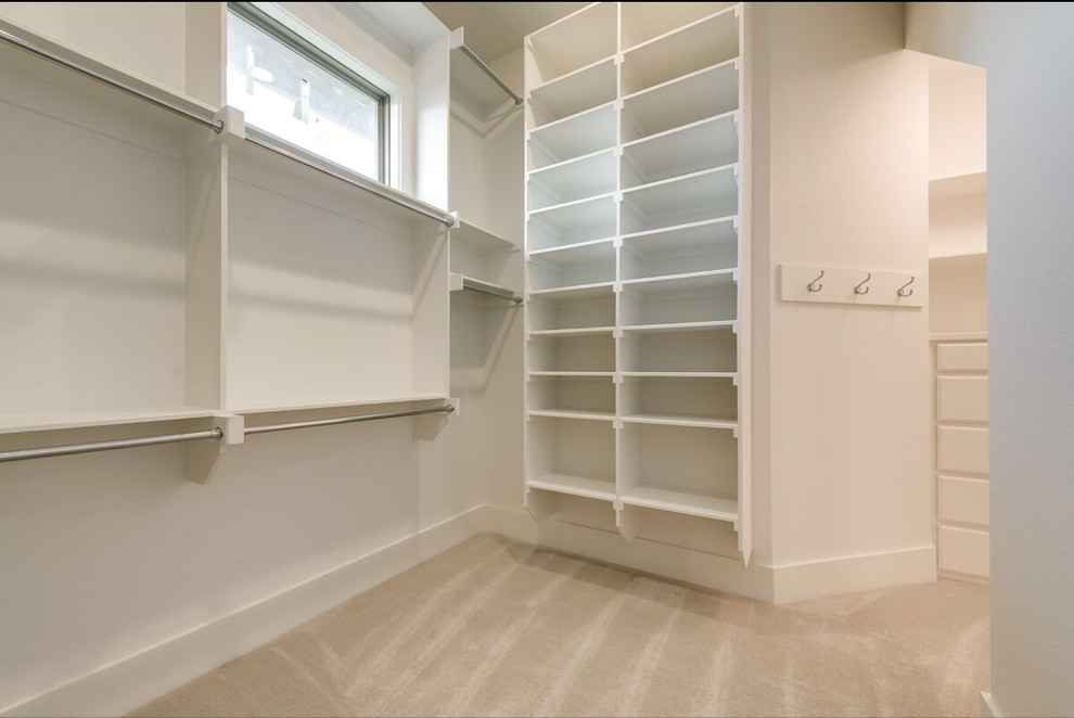 Foto de armario vestidor unisex contemporáneo de tamaño medio con armarios con paneles lisos, puertas de armario blancas y moqueta