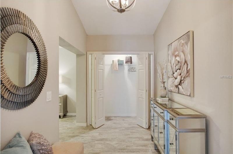 Inspiration for an expansive coastal walk-in wardrobe for women in San Diego with porcelain flooring and grey floors.