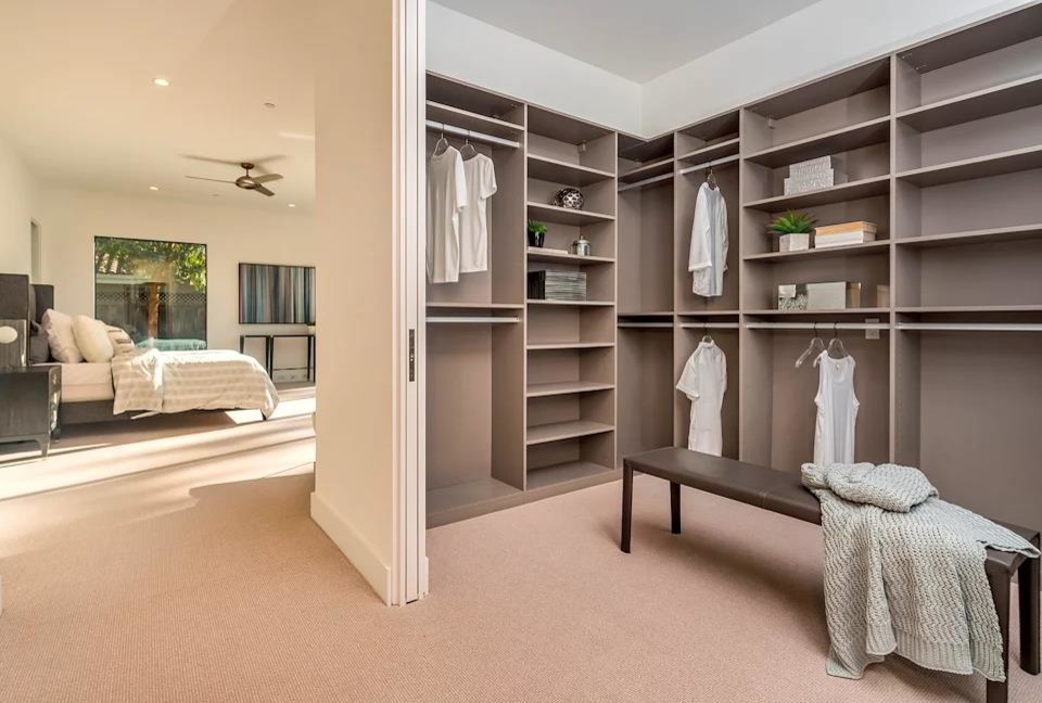 Dressing room - huge modern gender-neutral carpeted dressing room idea in San Francisco with open cabinets