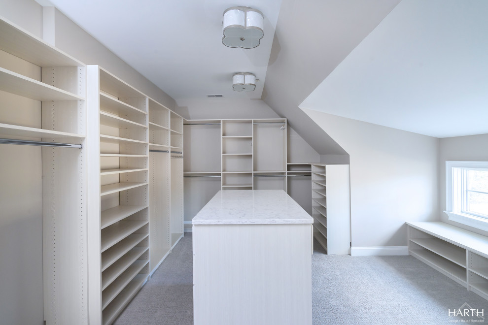 Large transitional women's carpeted and beige floor walk-in closet photo in Philadelphia with flat-panel cabinets and light wood cabinets
