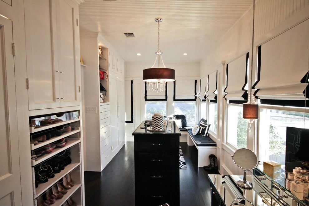 Example of a transitional women's dark wood floor dressing room design in Austin with white cabinets