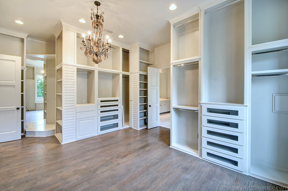 Mediterranean dressing room in Dallas with white cabinets and medium hardwood flooring.
