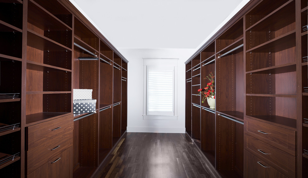 Large classic gender neutral walk-in wardrobe in Tampa with open cabinets, dark wood cabinets, dark hardwood flooring and brown floors.
