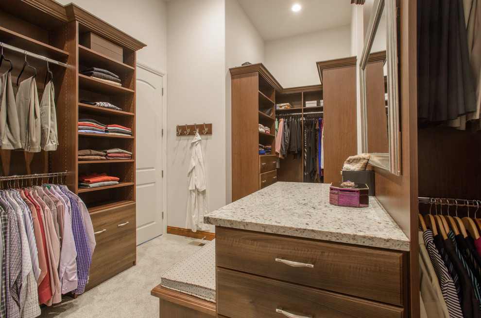 Design ideas for a large walk-in wardrobe in Denver with medium wood cabinets.