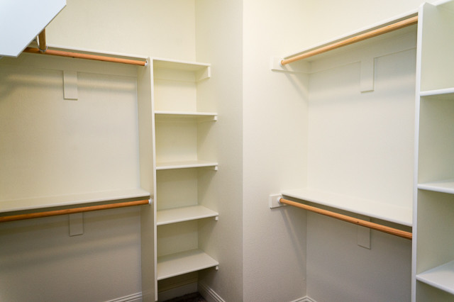 Inspiration for a large classic walk-in wardrobe in Portland with open cabinets, white cabinets and carpet.
