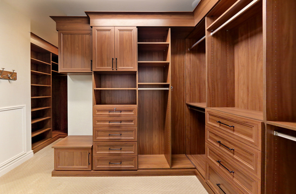 Photo of an expansive classic walk-in wardrobe for women in Richmond with recessed-panel cabinets, medium wood cabinets, carpet and beige floors.