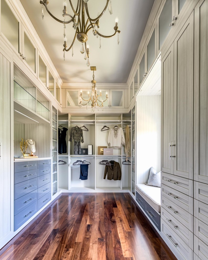Large classic gender neutral dressing room in Nashville with recessed-panel cabinets, grey cabinets, dark hardwood flooring and brown floors.