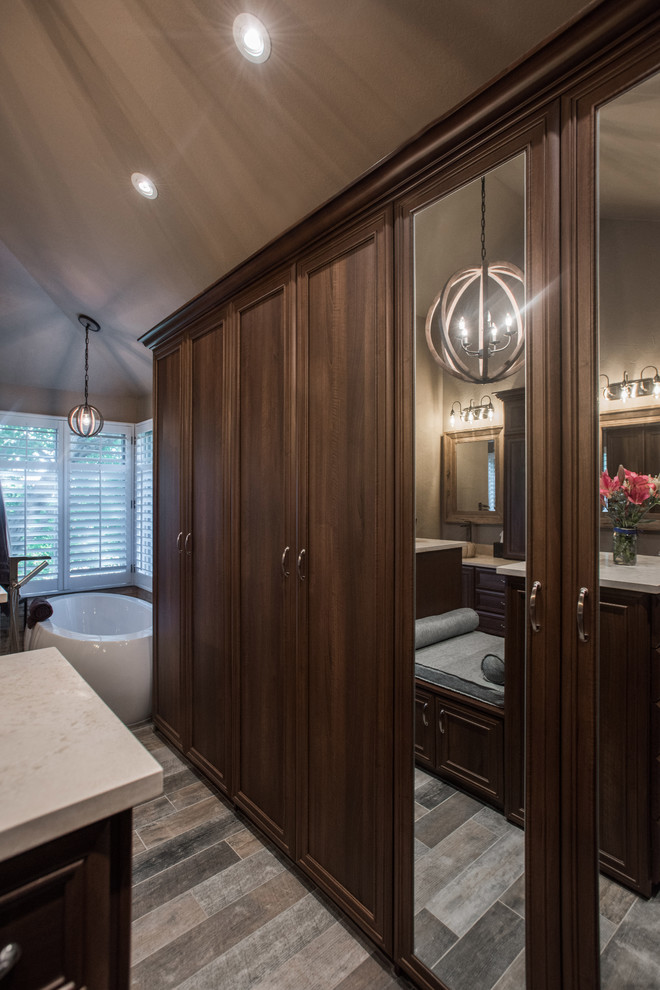 Large transitional limestone floor and gray floor walk-in closet photo in Denver with recessed-panel cabinets and medium tone wood cabinets