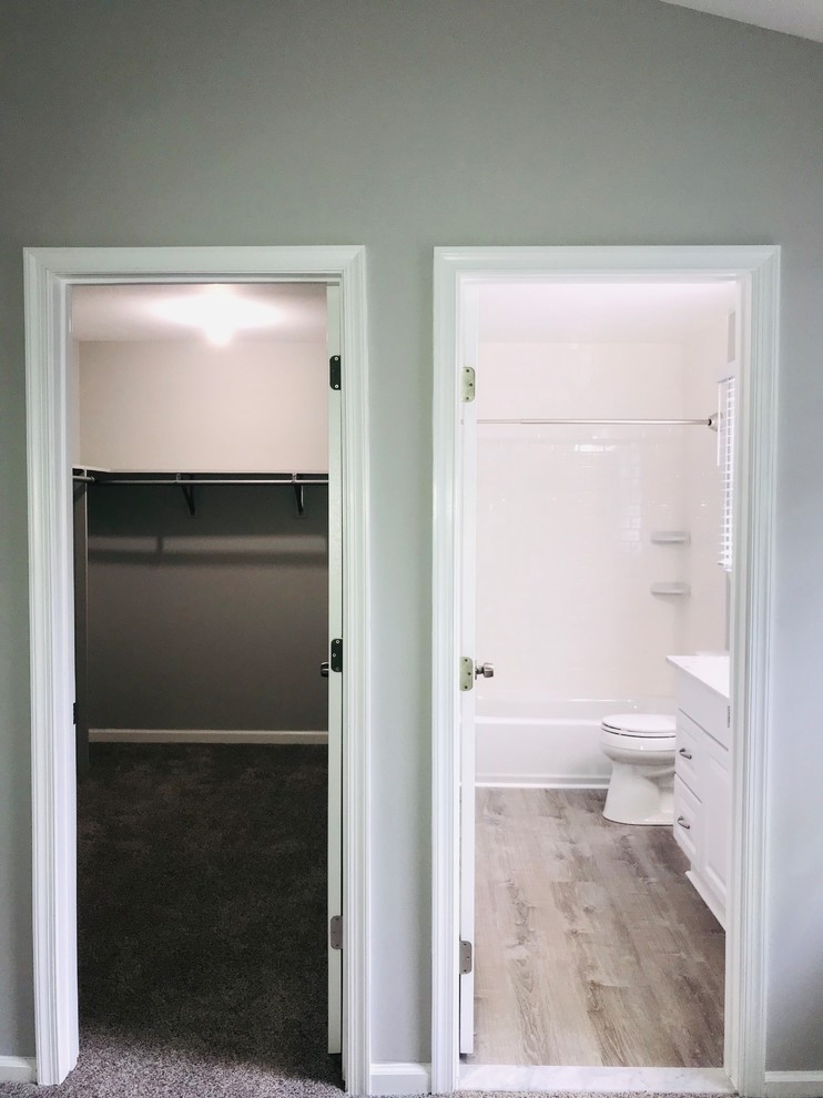Inspiration for a medium sized traditional gender neutral walk-in wardrobe in Richmond with open cabinets, white cabinets, carpet and grey floors.