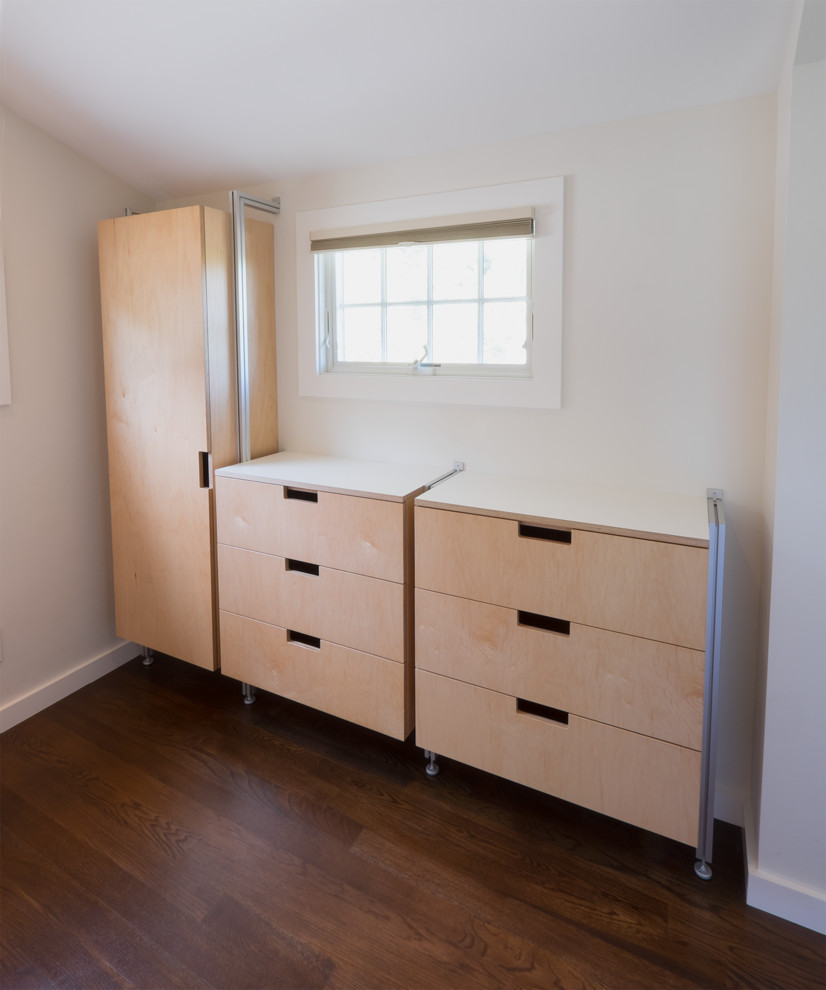 This is an example of a modern walk-in wardrobe in San Francisco with flat-panel cabinets, light wood cabinets, dark hardwood flooring and brown floors.