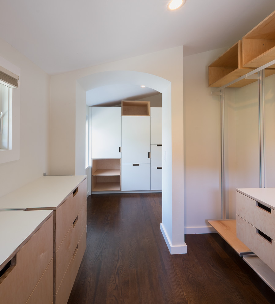 Design ideas for a medium sized modern walk-in wardrobe in San Francisco with flat-panel cabinets, light wood cabinets, dark hardwood flooring and brown floors.