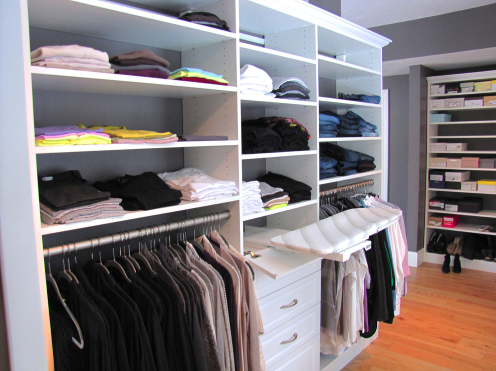 Master bedroom walkin closet with pullout ironing board, plenty of drawe Contemporary