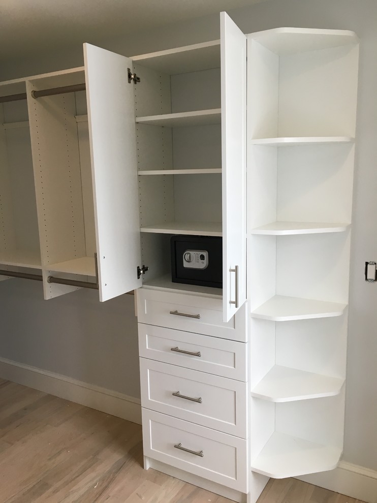 Mid-sized transitional gender-neutral medium tone wood floor and brown floor walk-in closet photo in New York with recessed-panel cabinets and white cabinets