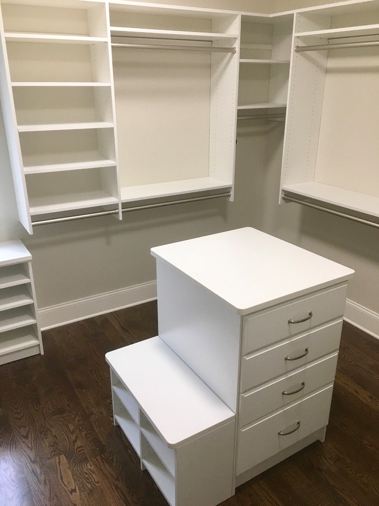 Mid-sized transitional gender-neutral medium tone wood floor reach-in closet photo in New York with shaker cabinets and white cabinets