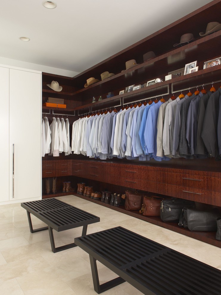 Inspiration for a contemporary walk-in wardrobe for men in Detroit with dark wood cabinets.