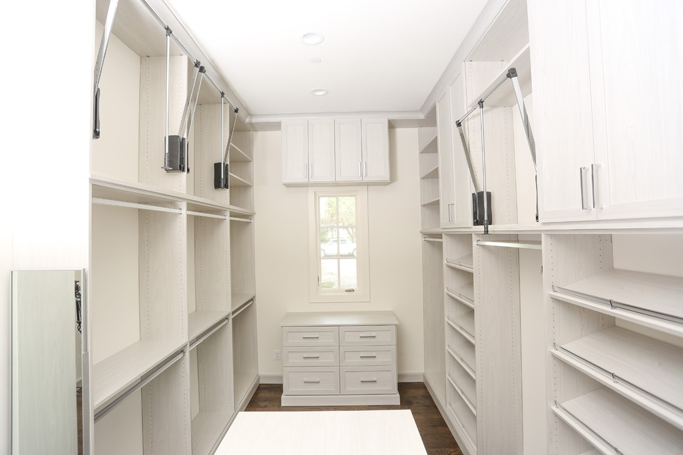 Inspiration for an expansive contemporary gender neutral walk-in wardrobe in Atlanta with shaker cabinets, medium hardwood flooring, brown floors and light wood cabinets.