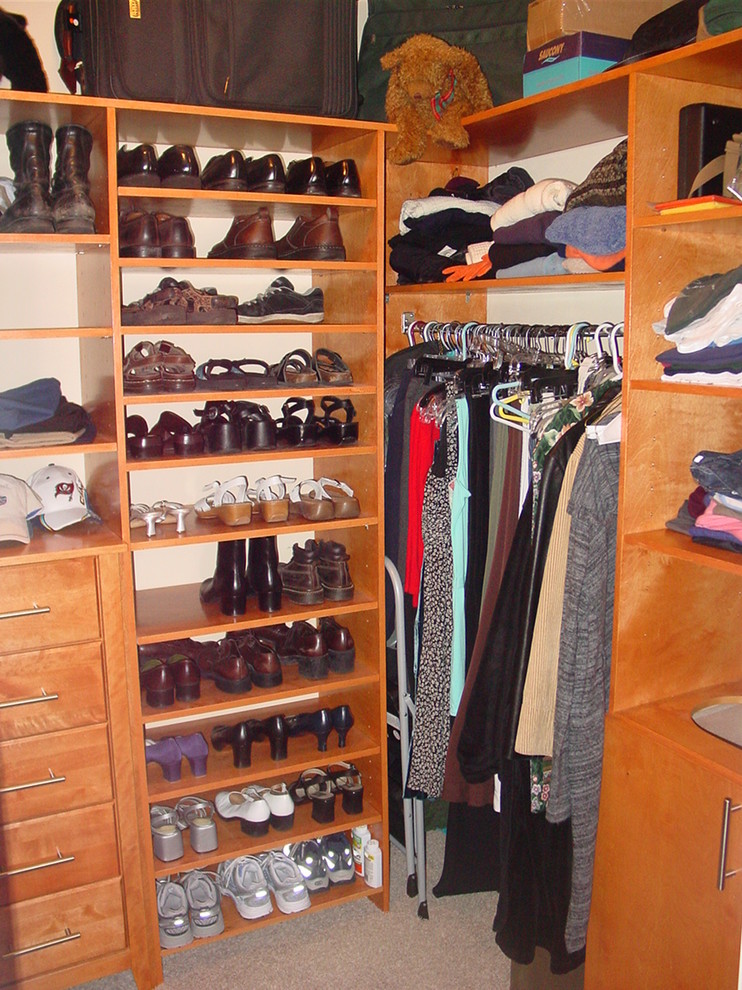 Mid-sized elegant gender-neutral carpeted walk-in closet photo in Miami with open cabinets and medium tone wood cabinets