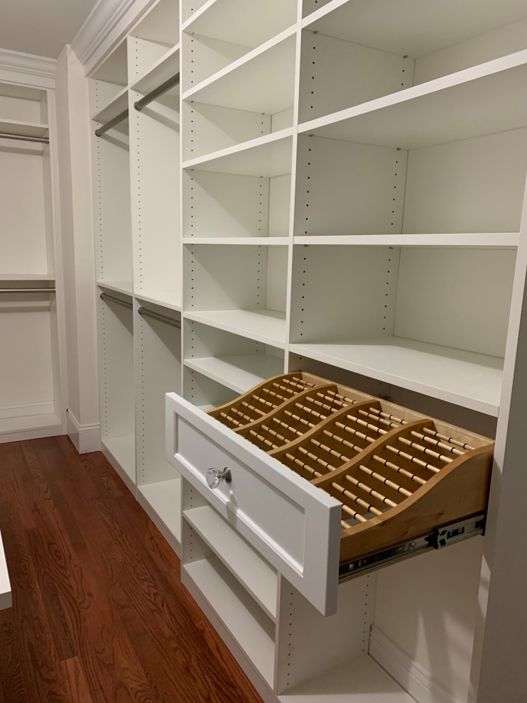 Walk-in closet - large traditional gender-neutral walk-in closet idea in New York with shaker cabinets and white cabinets