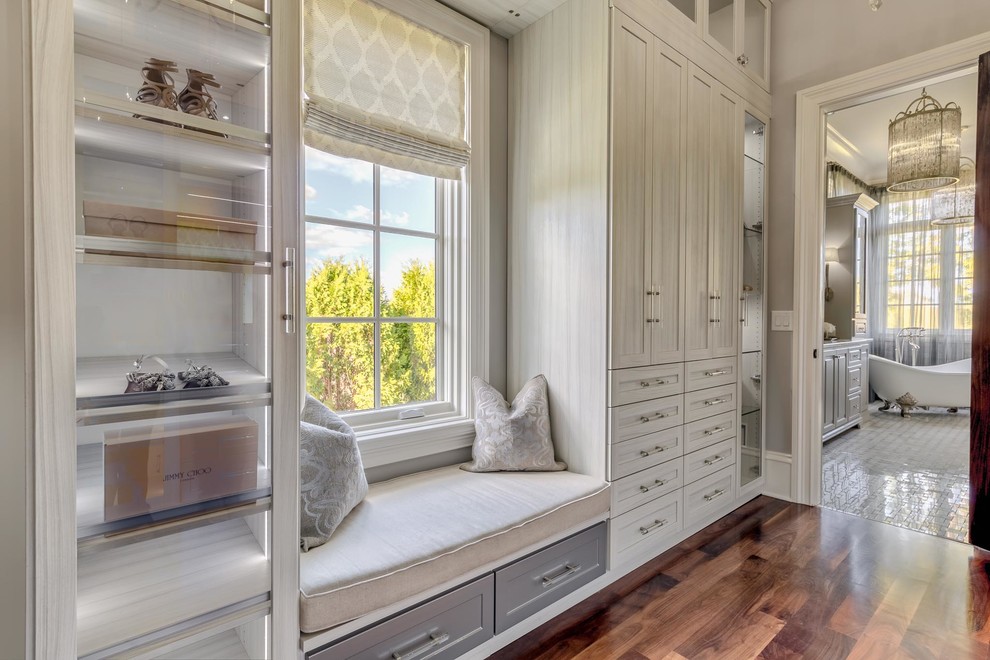 Inspiration for a large timeless gender-neutral dark wood floor and brown floor dressing room remodel in Nashville with recessed-panel cabinets and gray cabinets