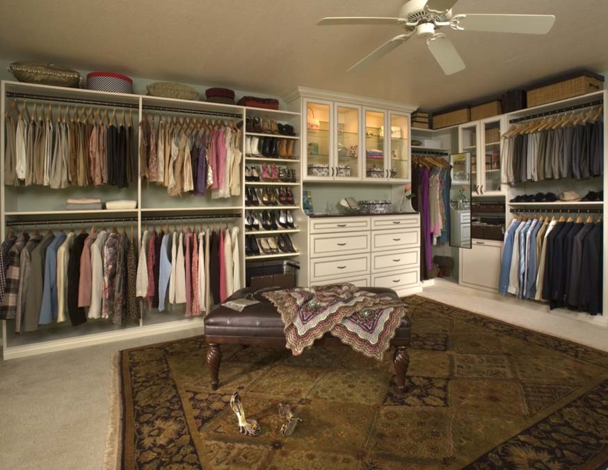 Photo of a large classic gender neutral walk-in wardrobe in Orange County with recessed-panel cabinets, white cabinets and carpet.