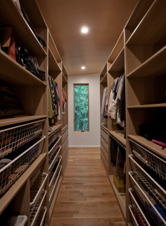 Big Walk in Closet with Beige and Light Wood Cabinets