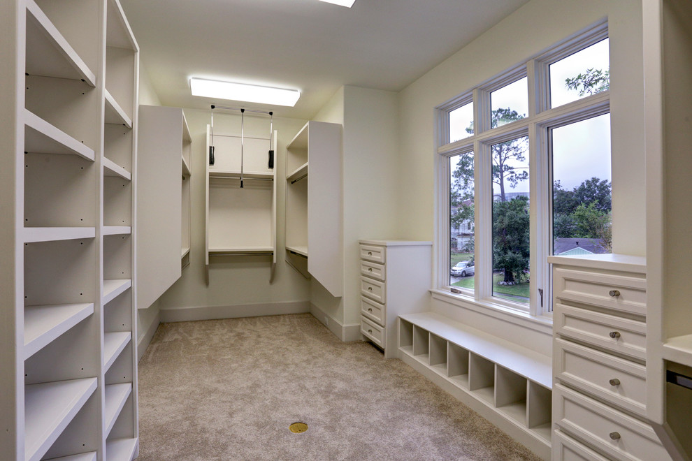 Example of a large transitional women's carpeted walk-in closet design in Houston with recessed-panel cabinets and white cabinets