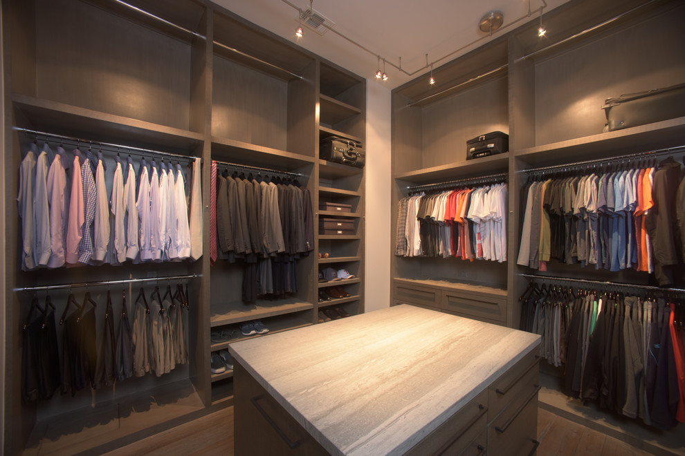 Photo of a large modern walk-in wardrobe for men in Houston with brown cabinets, flat-panel cabinets and painted wood flooring.