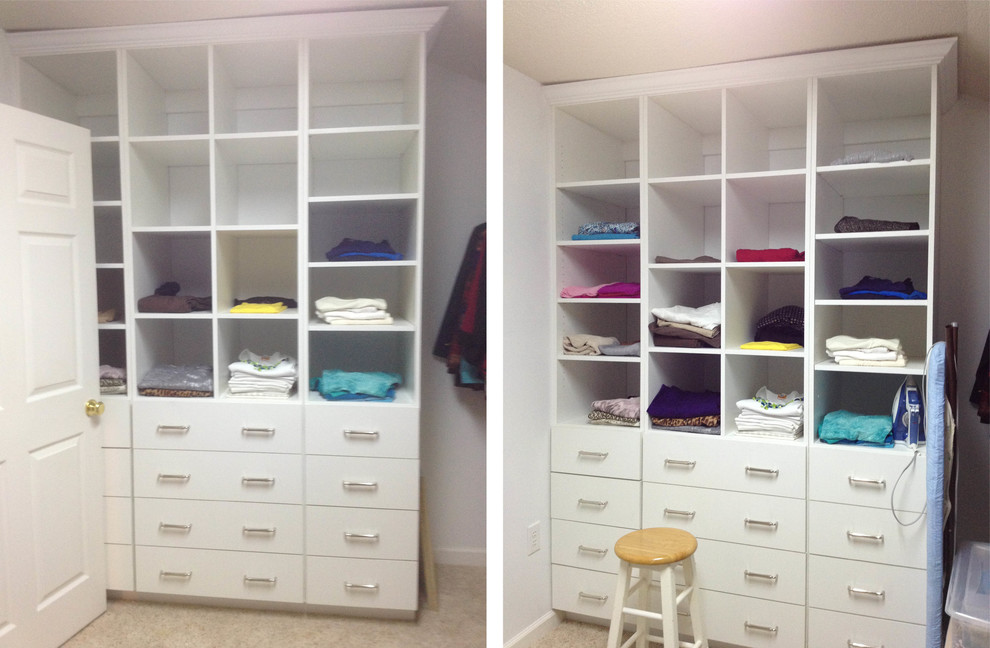 Design ideas for a medium sized classic gender neutral walk-in wardrobe in Charlotte with flat-panel cabinets, white cabinets and carpet.