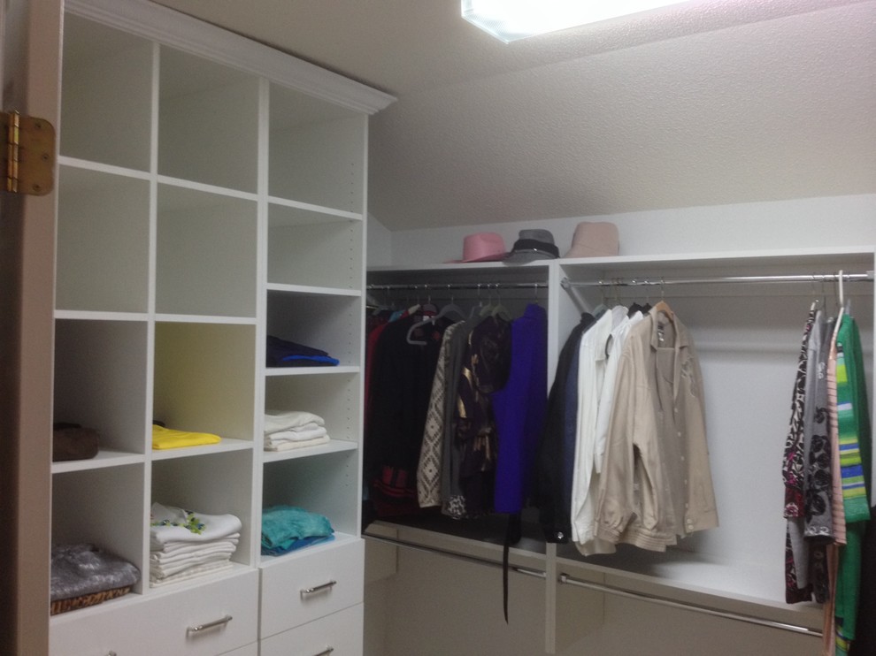 Photo of a medium sized classic gender neutral walk-in wardrobe in Charlotte with flat-panel cabinets, white cabinets and carpet.