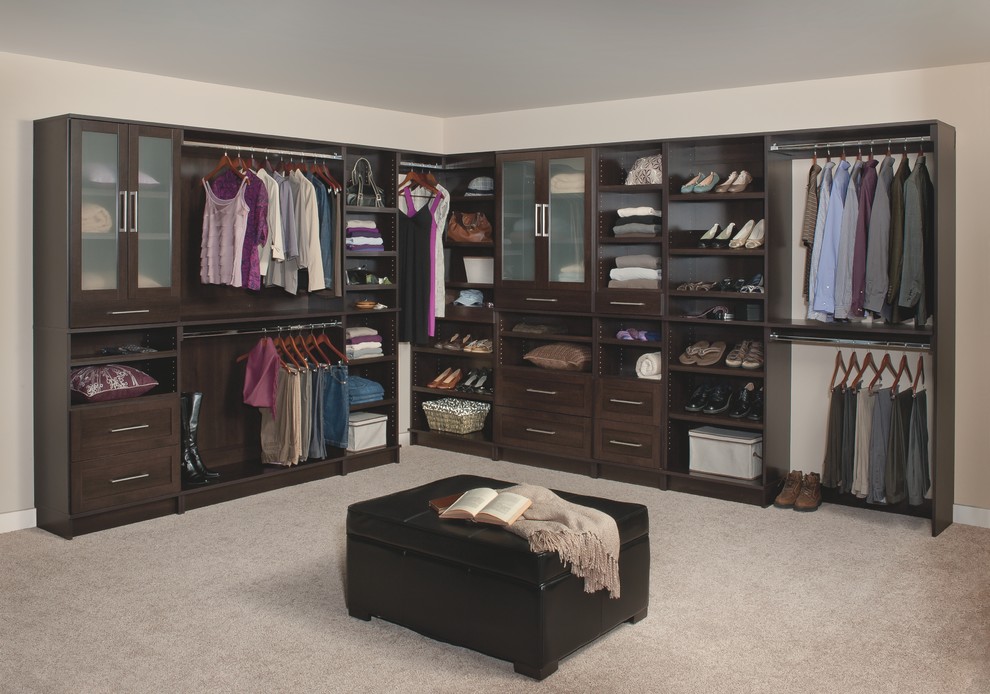 Inspiration for an expansive traditional gender neutral walk-in wardrobe in Other with shaker cabinets, dark wood cabinets, carpet and grey floors.