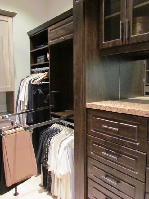 Dressing room - large traditional gender-neutral carpeted and beige floor dressing room idea in Atlanta with raised-panel cabinets and dark wood cabinets