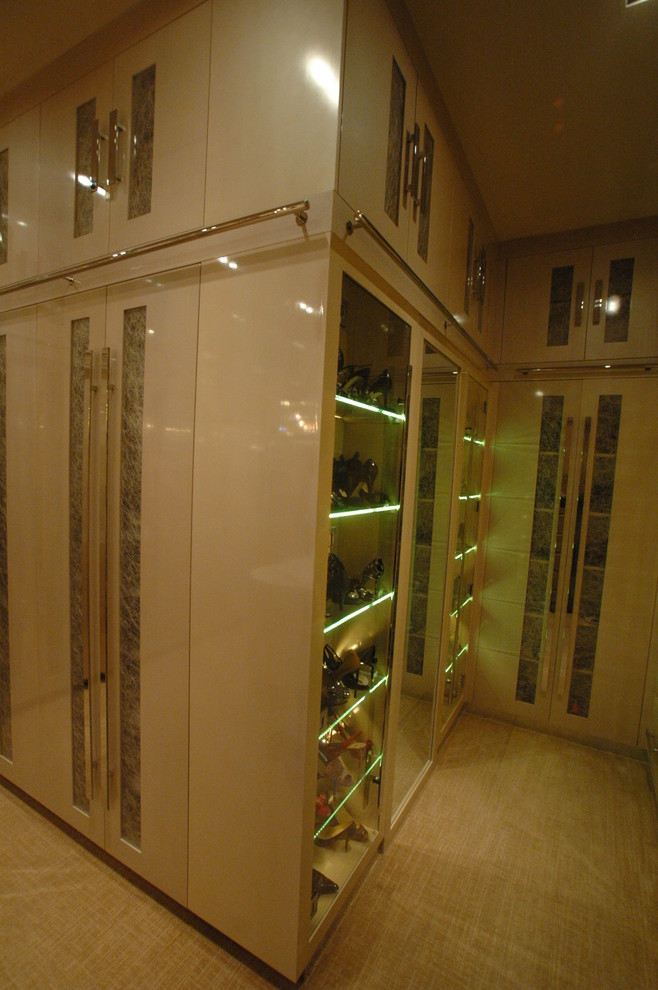 Photo of a large classic walk-in wardrobe for women in Las Vegas with flat-panel cabinets, beige cabinets and carpet.