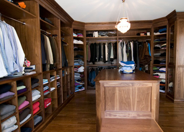Large men's medium tone wood floor walk-in closet photo in New York with open cabinets and medium tone wood cabinets