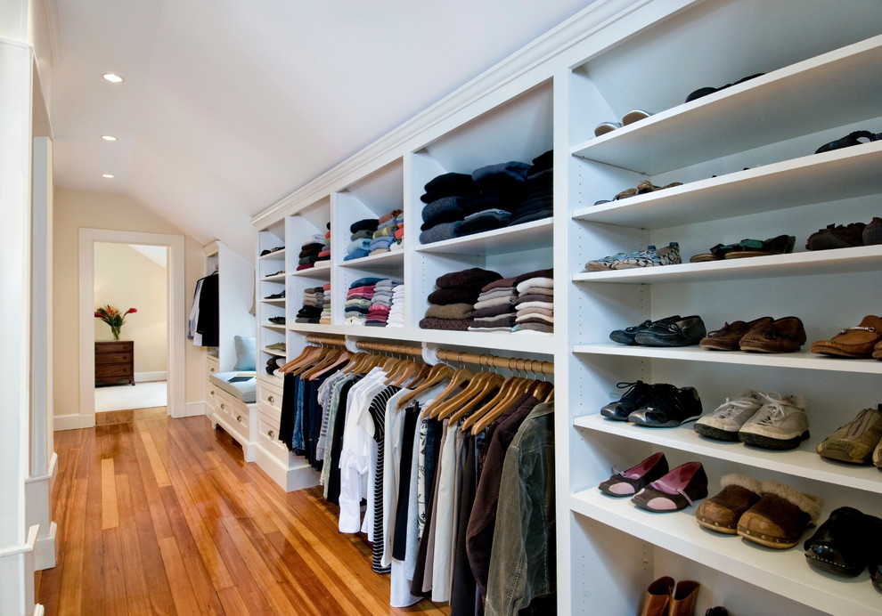 This is an example of a classic wardrobe in Boston with medium hardwood flooring.