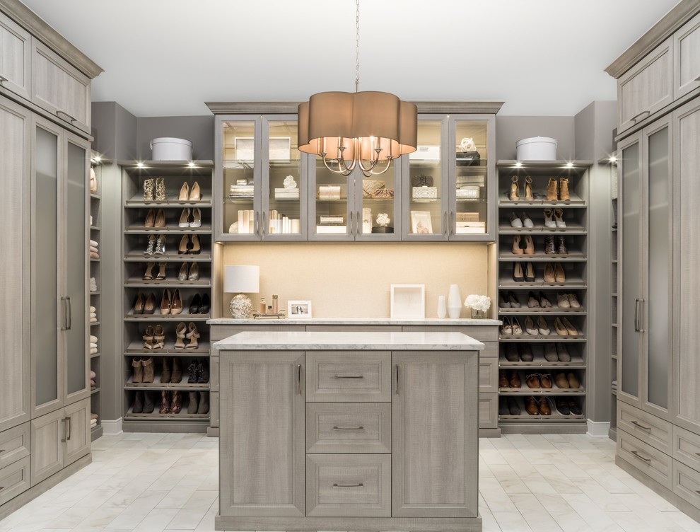 Design ideas for an expansive modern gender neutral walk-in wardrobe in Chicago with beige floors, grey cabinets and recessed-panel cabinets.