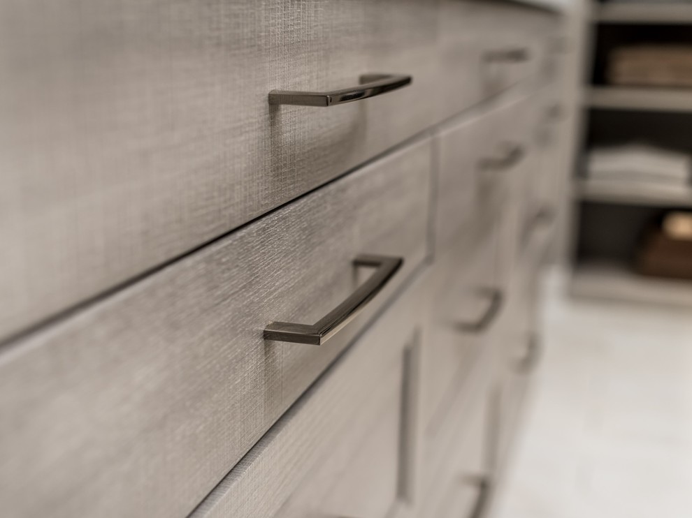 Walk-in closet - huge modern gender-neutral light wood floor and beige floor walk-in closet idea in Chicago with shaker cabinets and medium tone wood cabinets