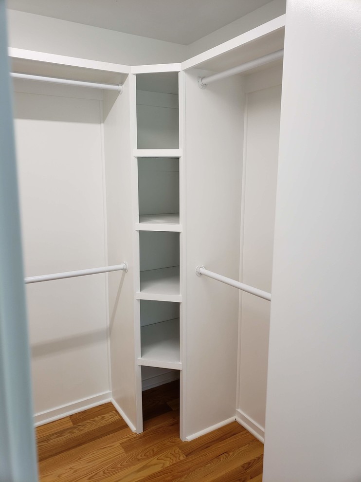 Design ideas for a medium sized contemporary gender neutral walk-in wardrobe in Raleigh with open cabinets, white cabinets, medium hardwood flooring and brown floors.