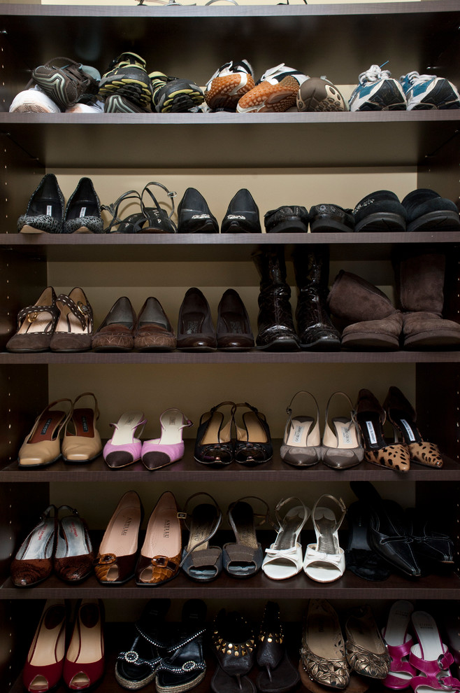 Inspiration for a classic gender neutral walk-in wardrobe in Philadelphia with dark wood cabinets.