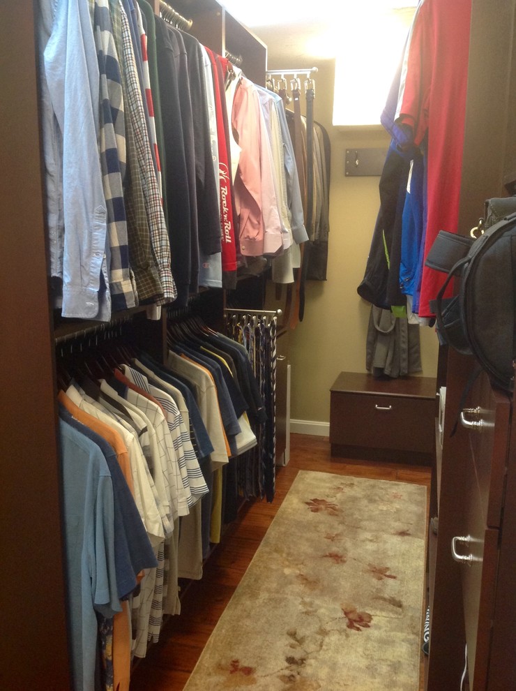 Inspiration for a large classic walk-in wardrobe for men in Boston with flat-panel cabinets, medium wood cabinets and medium hardwood flooring.