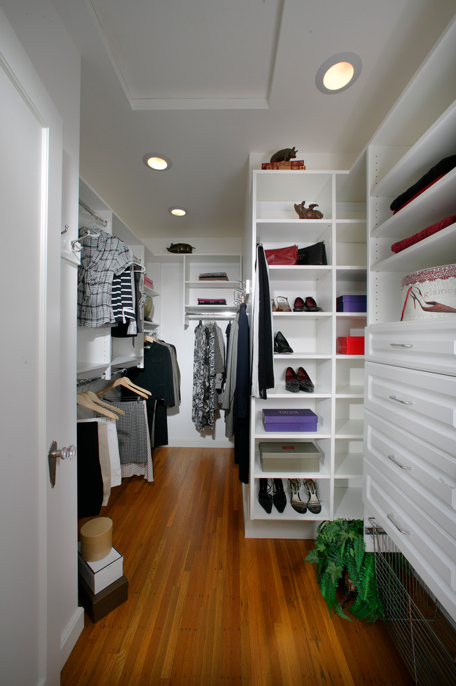 Walk-in closet - mid-sized transitional women's light wood floor walk-in closet idea in Sacramento with raised-panel cabinets and white cabinets