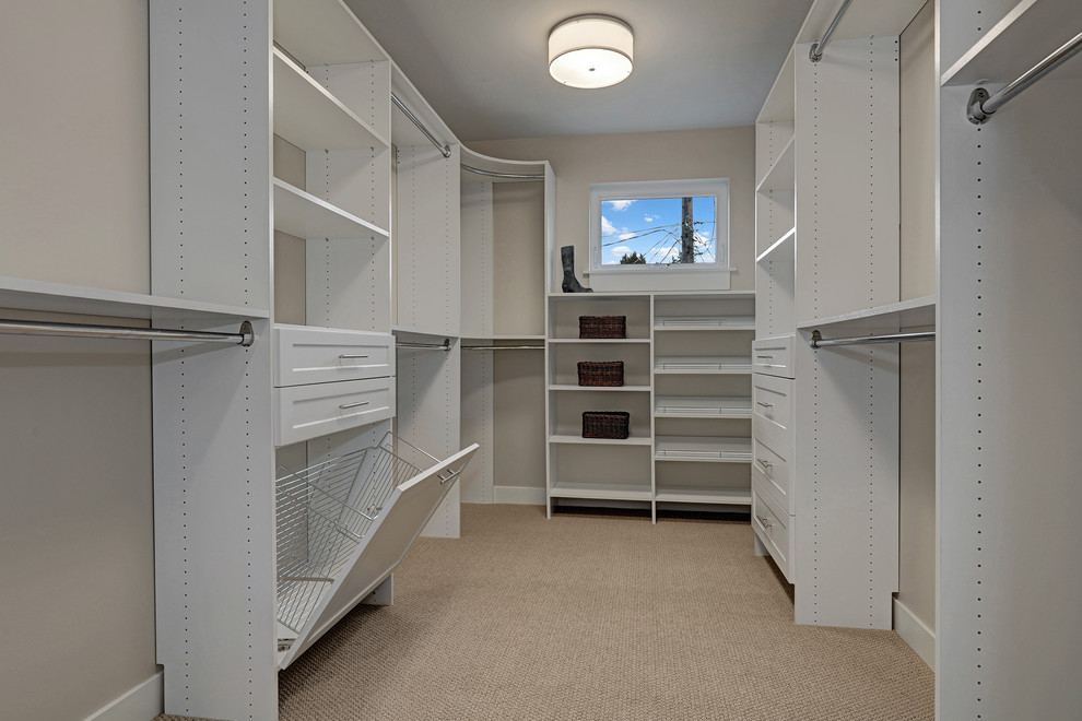 Photo of a rural gender neutral walk-in wardrobe in Seattle with white cabinets and carpet.