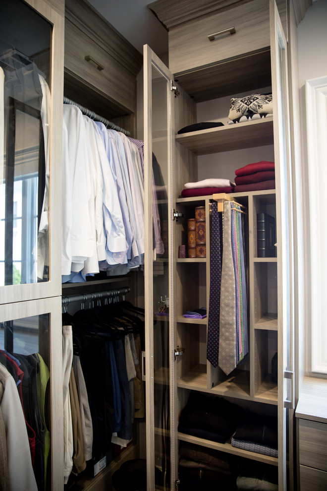 Photo of a large contemporary walk-in wardrobe for women in Atlanta with flat-panel cabinets, grey cabinets, dark hardwood flooring and brown floors.