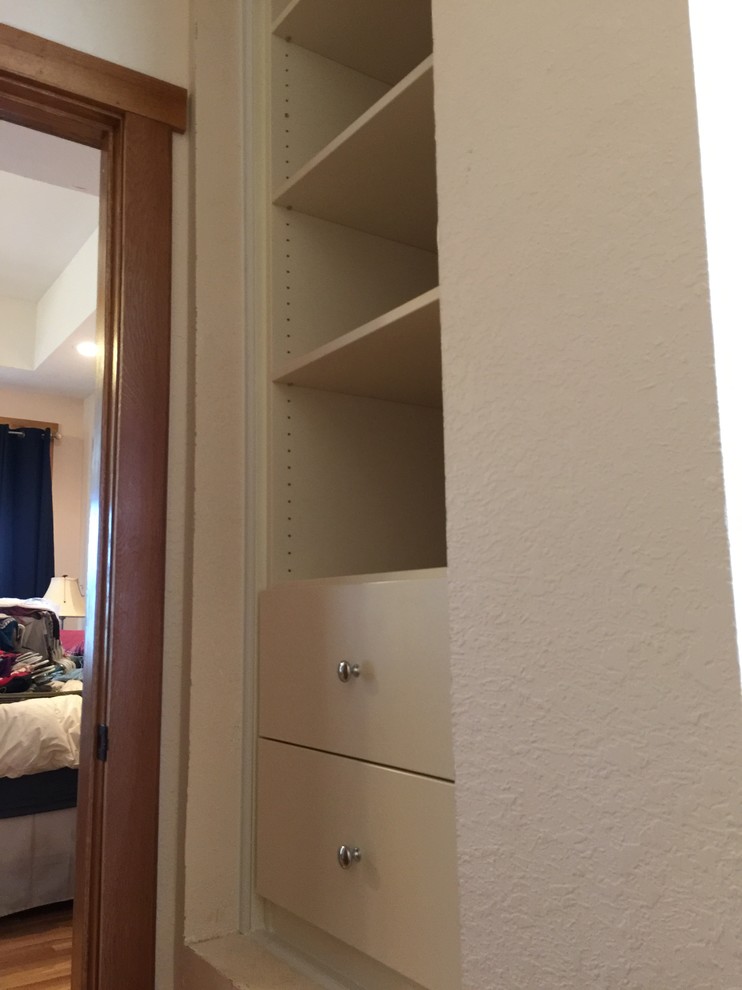 Medium sized traditional gender neutral walk-in wardrobe in Other with flat-panel cabinets and beige cabinets.