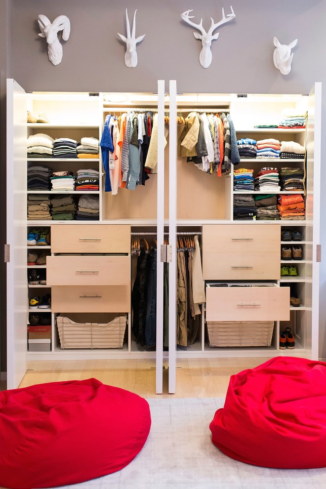 Small trendy gender-neutral light wood floor reach-in closet photo in New York with flat-panel cabinets and light wood cabinets