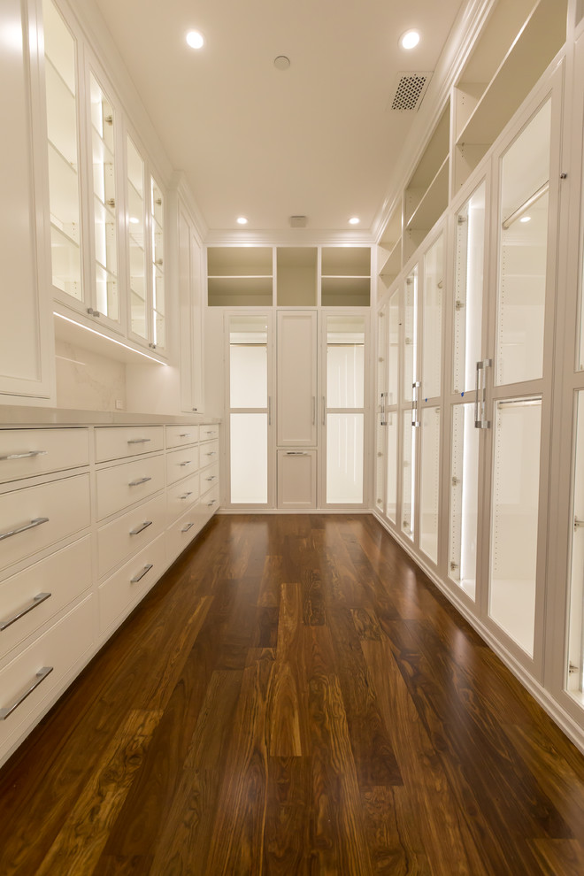 Photo of an expansive traditional walk-in wardrobe for men in Los Angeles with raised-panel cabinets.