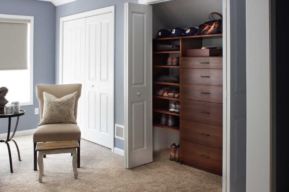 Example of a small trendy men's carpeted reach-in closet design in New York with flat-panel cabinets and dark wood cabinets